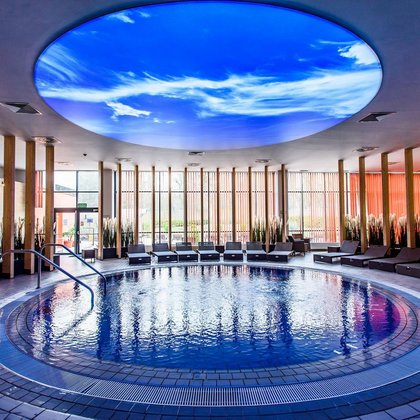 A pool with hot water in the Sauna Zone. Above the pool there is the part of ceiling which imitates the sky.